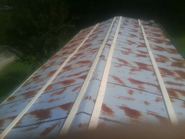 Rusted metal roof panels with new wood purlins before replacement — Storm Damage Roof Repair in Arcola by Roofing Brothers
